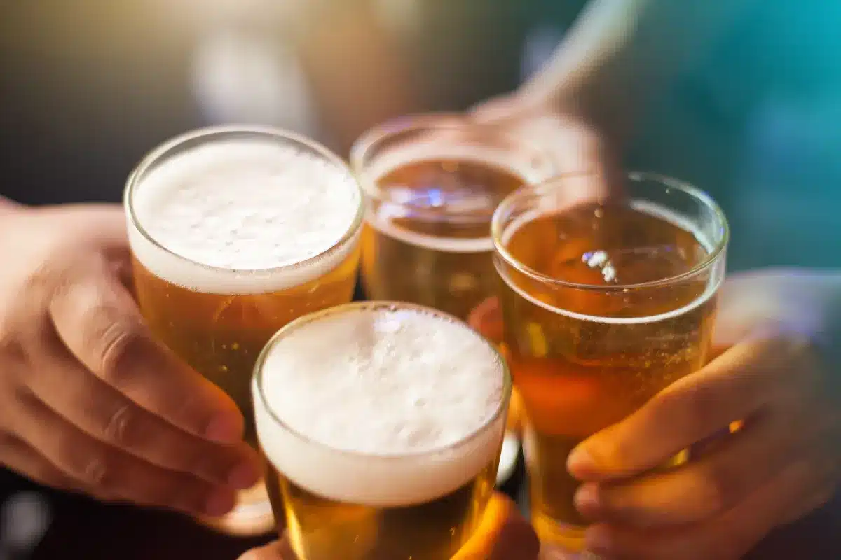 Four beer glasses touching