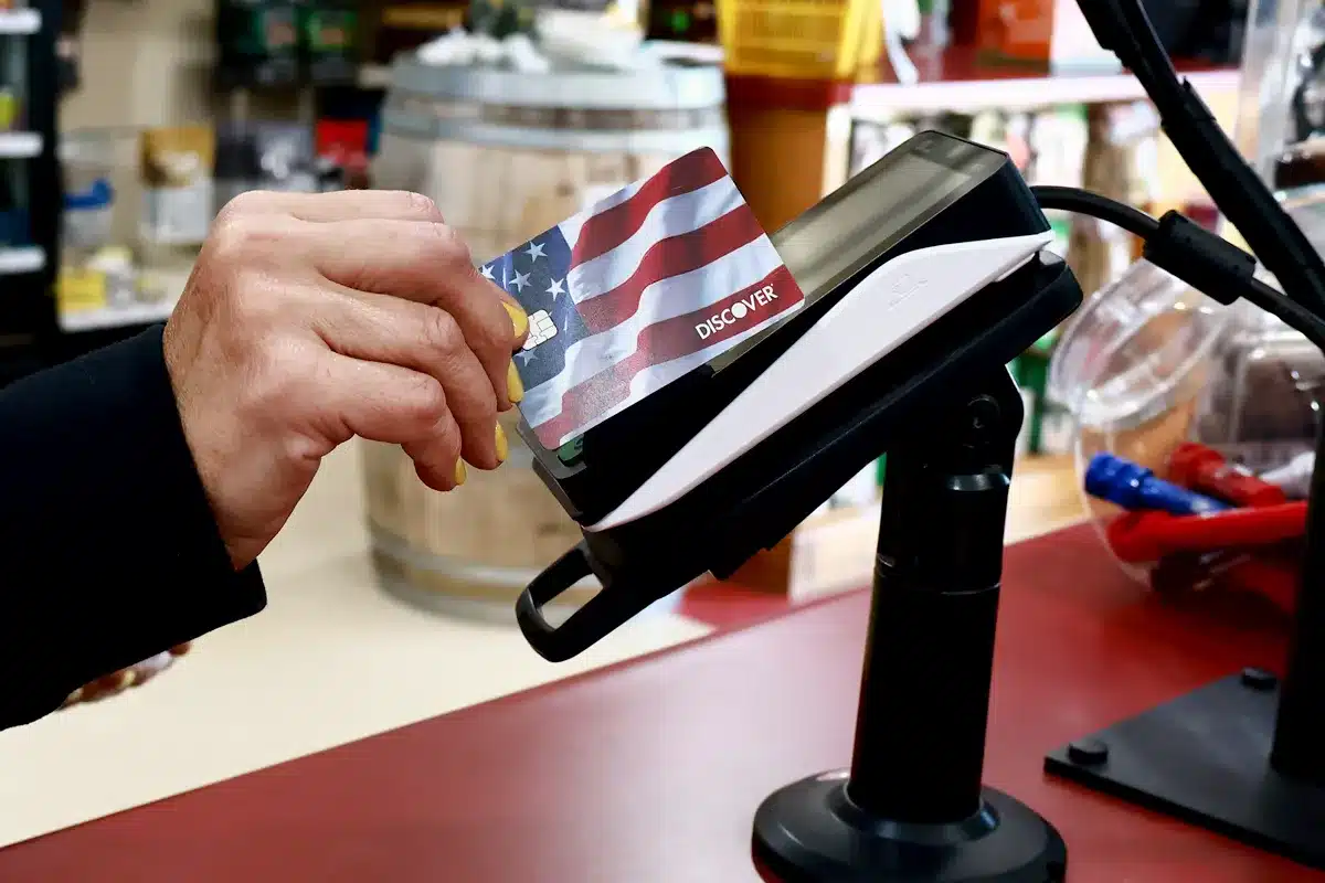 hand-holding-credit-card-near-payment-portal hand holding credit card near payment portal